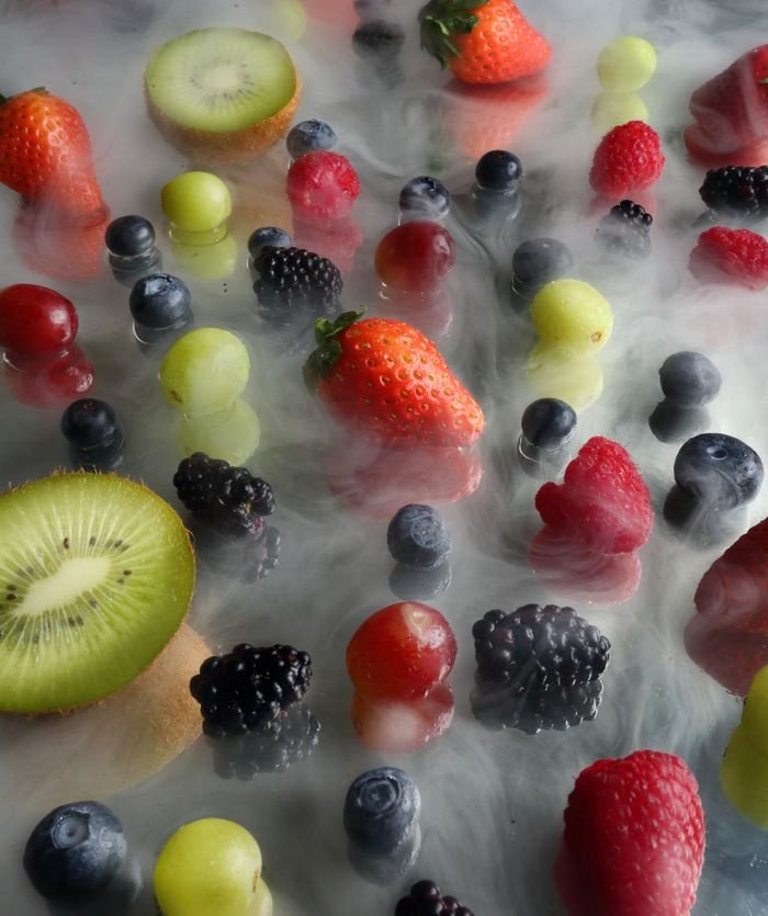 our-story Colorful assortment of fresh fruits with a smokey, artistic mist effect.