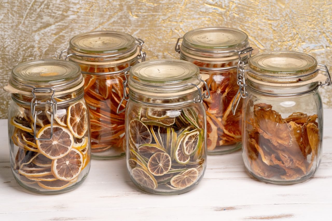 Crafting Captivating Headlines: Your awesome post title goes here Glass jars filled with preserved citrus and tropical fruit slices on a white table.